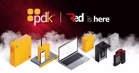 Verkada Installers A row of yellow and black security devices, a smartphone, and a laptop displaying software, with "pdk | Red is here" text above, on a smoky black and red background—ideal for Verkada Installers or anyone focused on Jendy Physical Security.